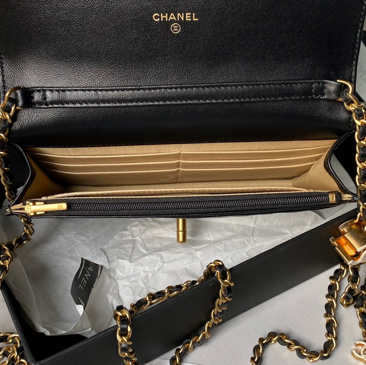 Black Chanel handbag with gold chain on a white background